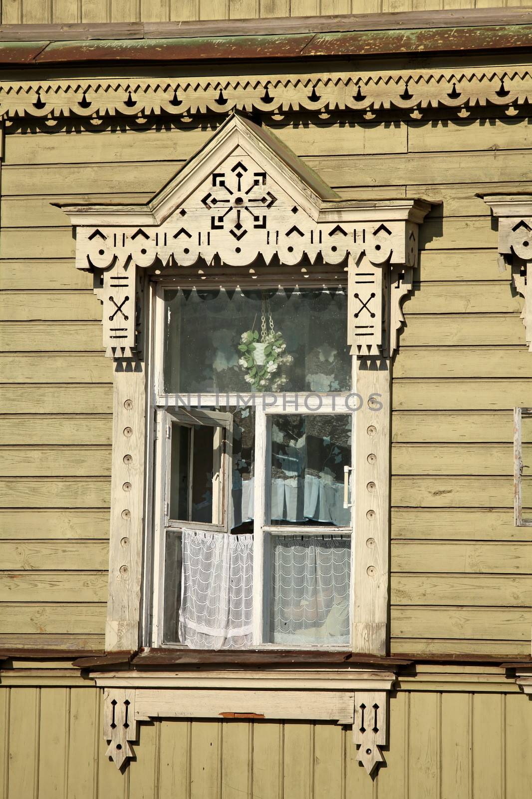 Window an old carved wooden house