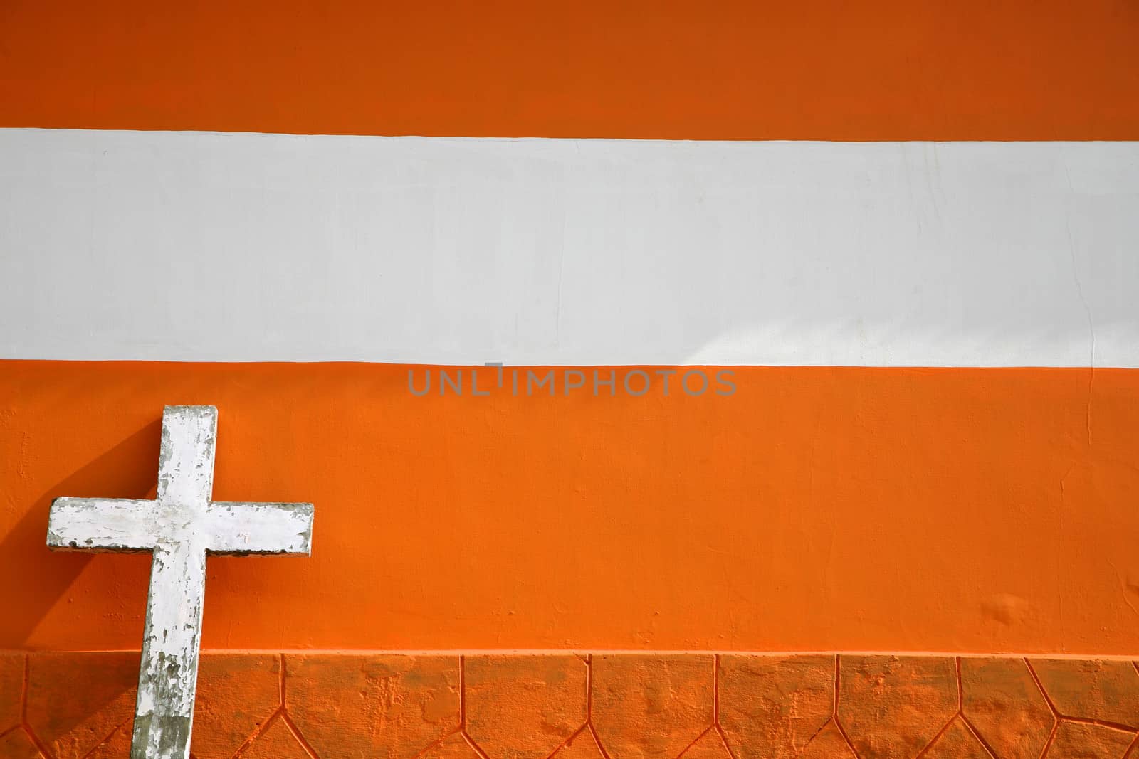 White Cross on Urban orange Brick Church in Kerala, India