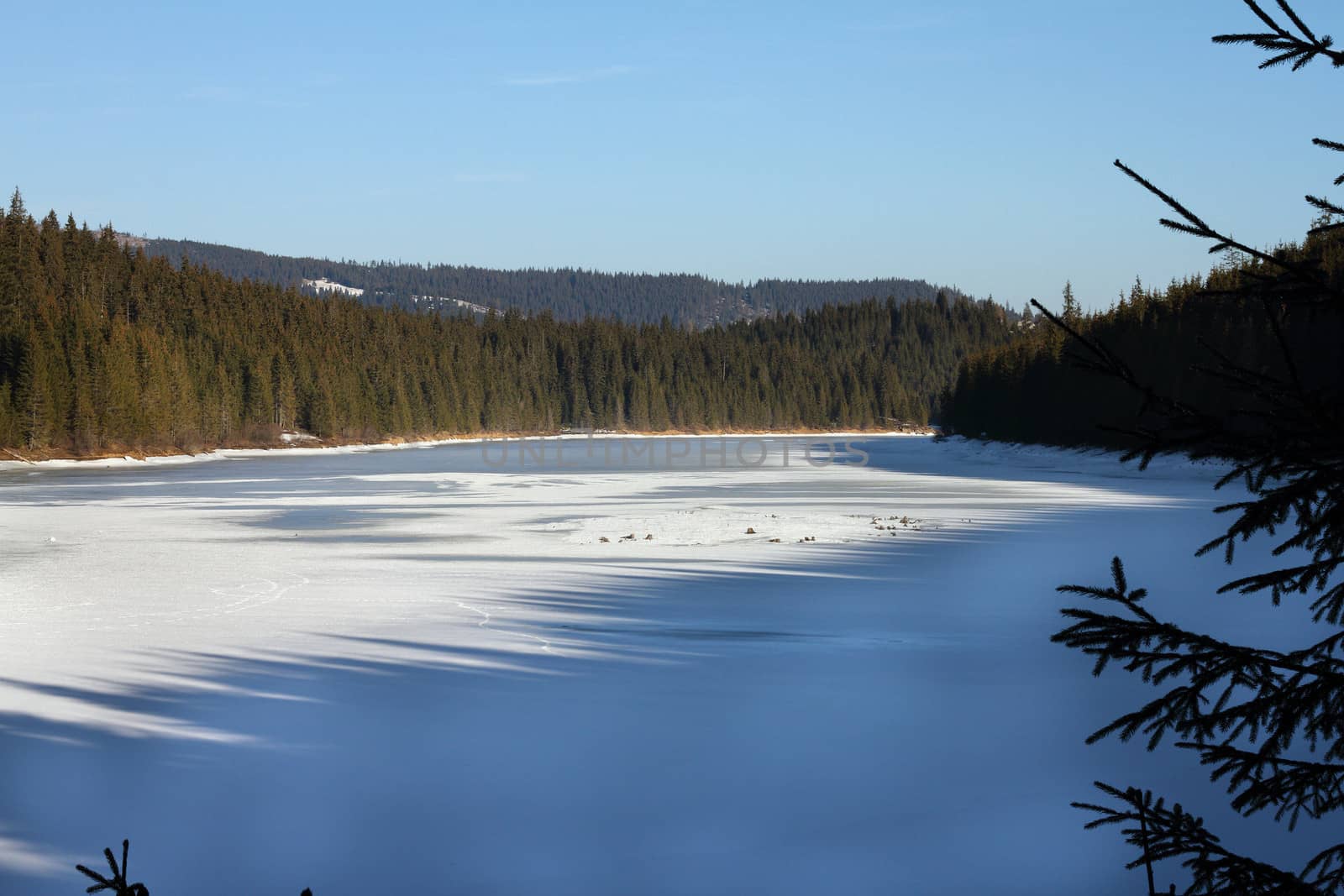 frozen mountain lake in late december, Belis, Romania