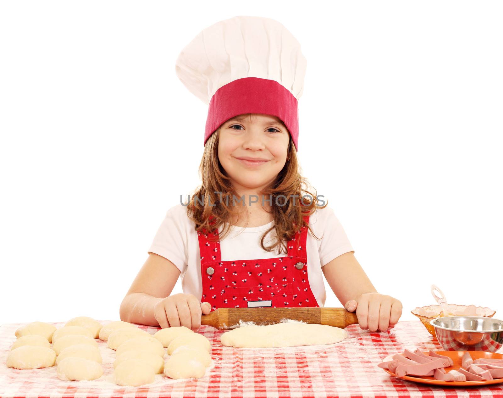 little girl kneading dough with rolling pin by goce