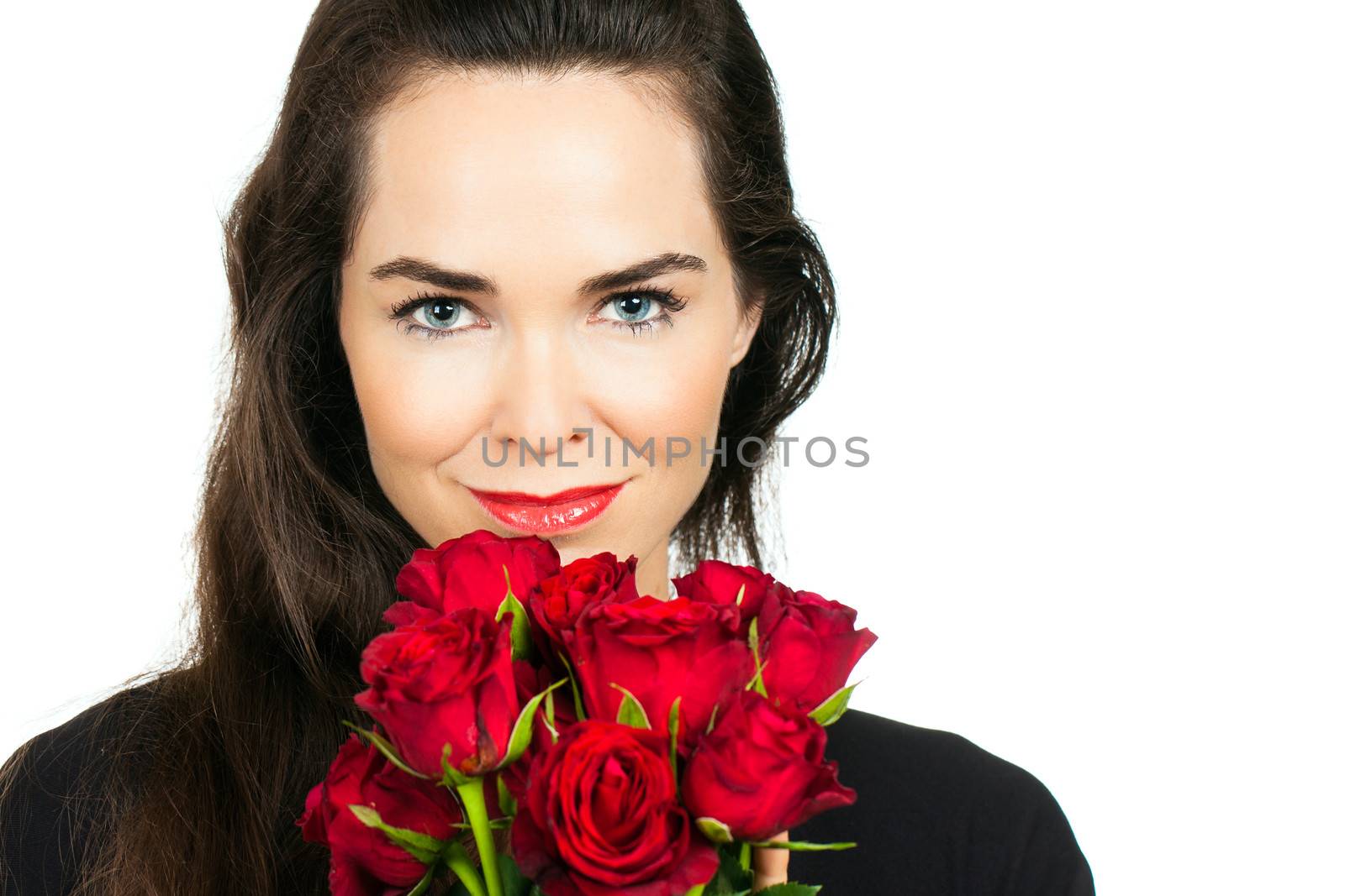 Beautiful woman holding and smelling a bunch of roses. Isolated on white.