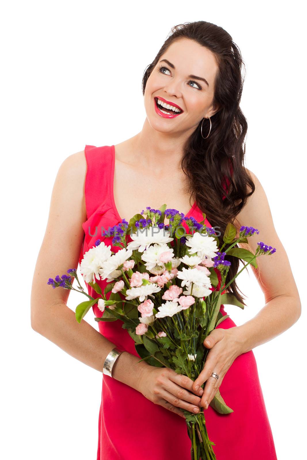A smiling beautiful woman holding flowers and looking at copy-space. Isolated on white.