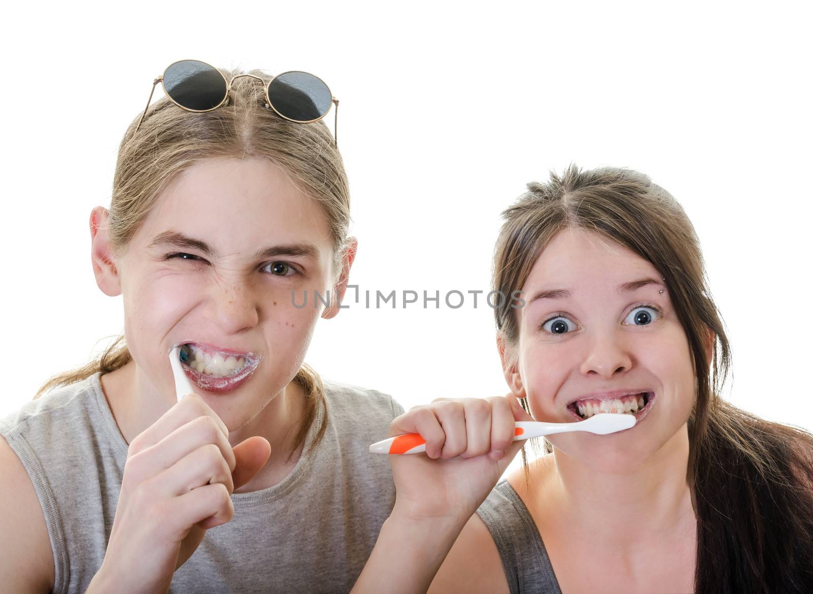 Young Couple Grimacing while Brushing their Teeth in front of camera, Horizontal Shot over White
