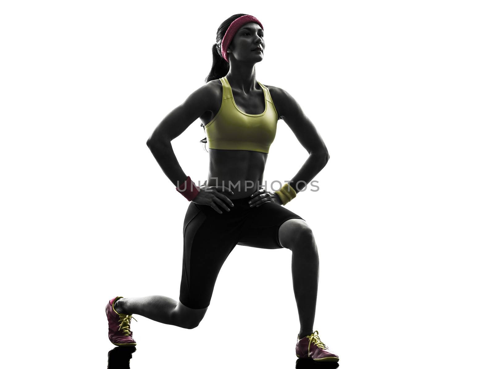 one woman exercising fitness workout lunges crouching in silhouette on white background