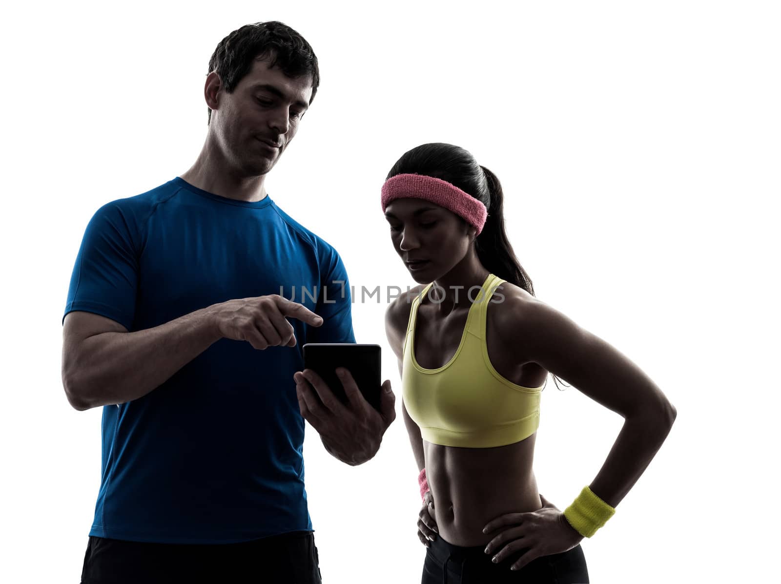 woman exercising fitness  man coach using digital tablet  silhou by PIXSTILL