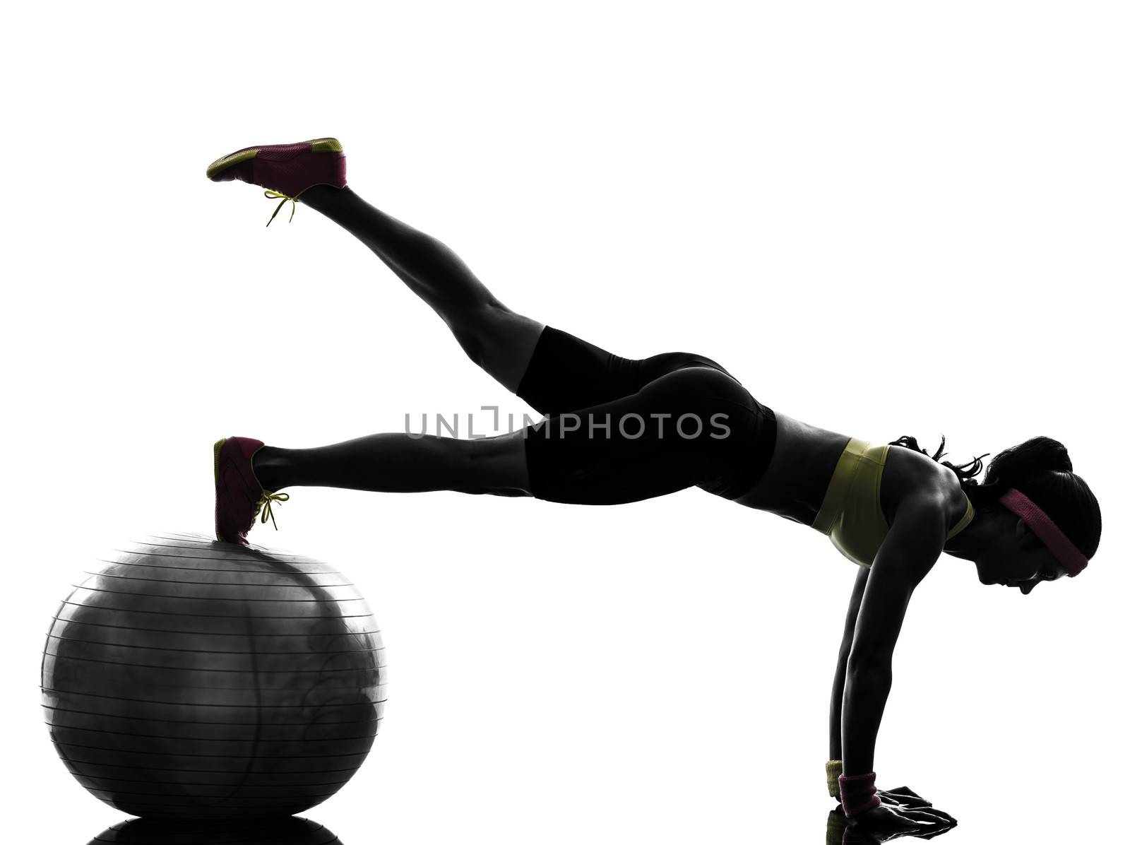 one woman exercising fitness workout plank position on fitness ball in silhouette on white background