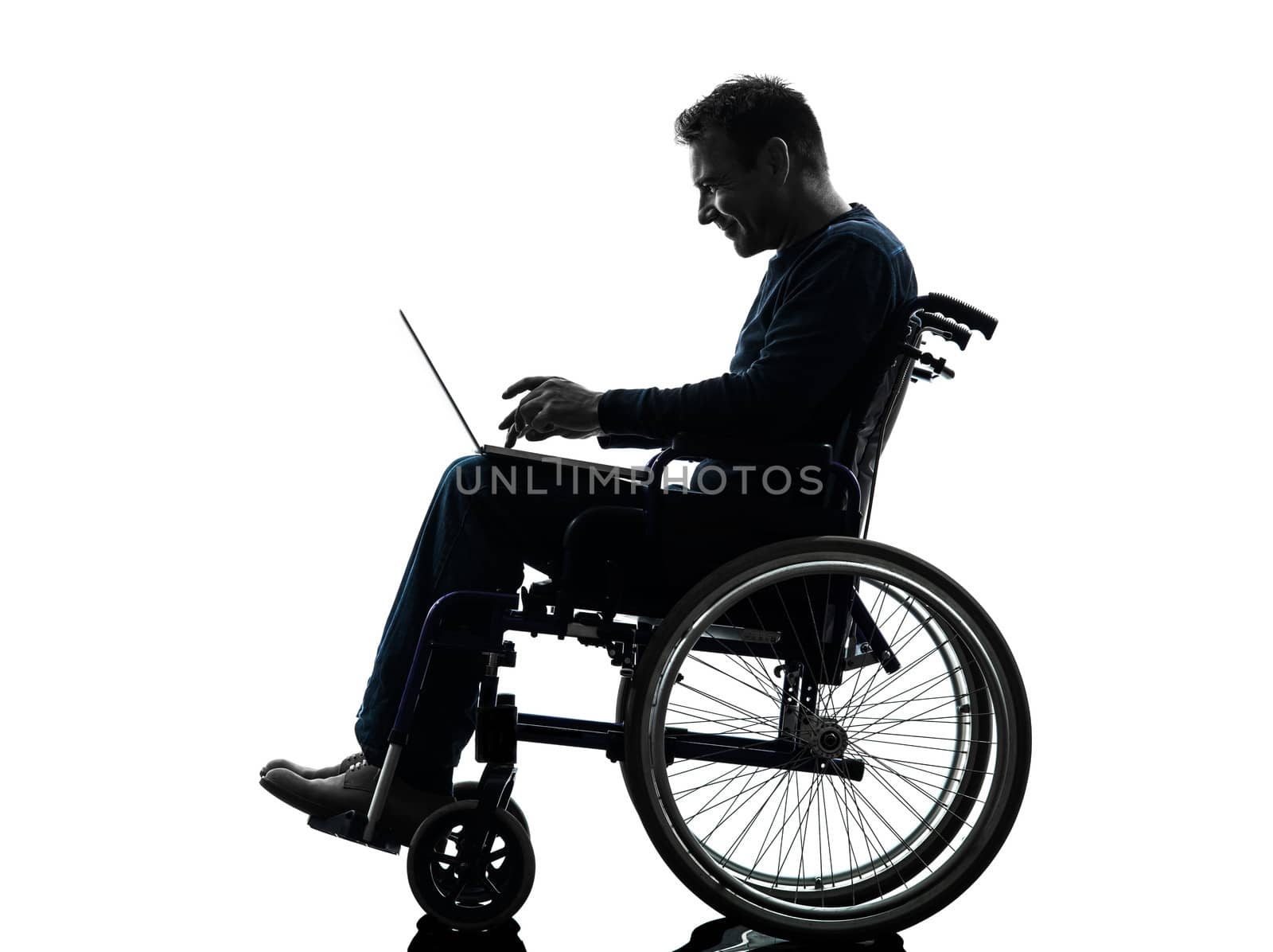 one handicapped man computing laptop computer in silhouette studio on white background