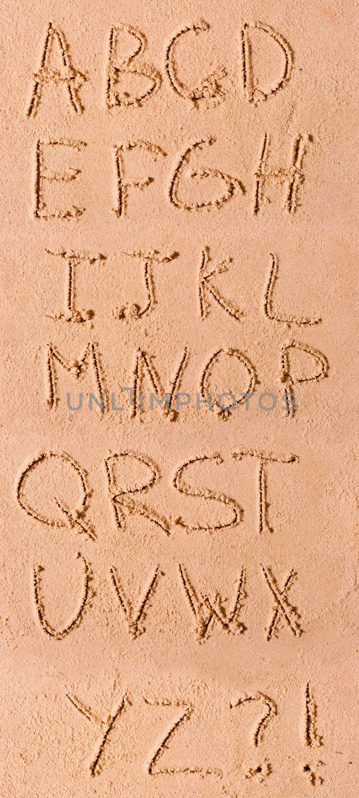 English alphabet written in sand on the beach by kosmsos111