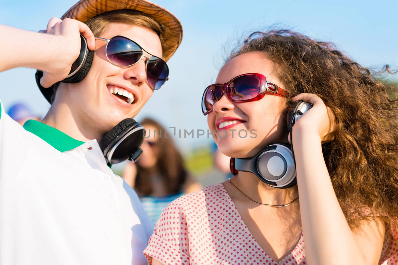 young couple standing on the road, having fun with friends