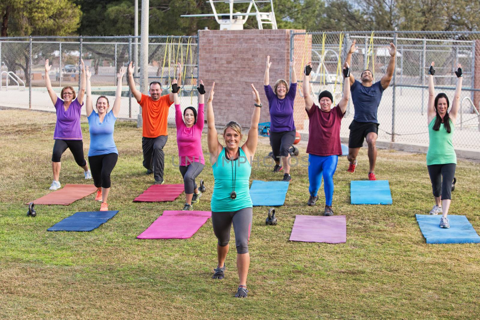 Diverse Group Exercising Outdoors by Creatista