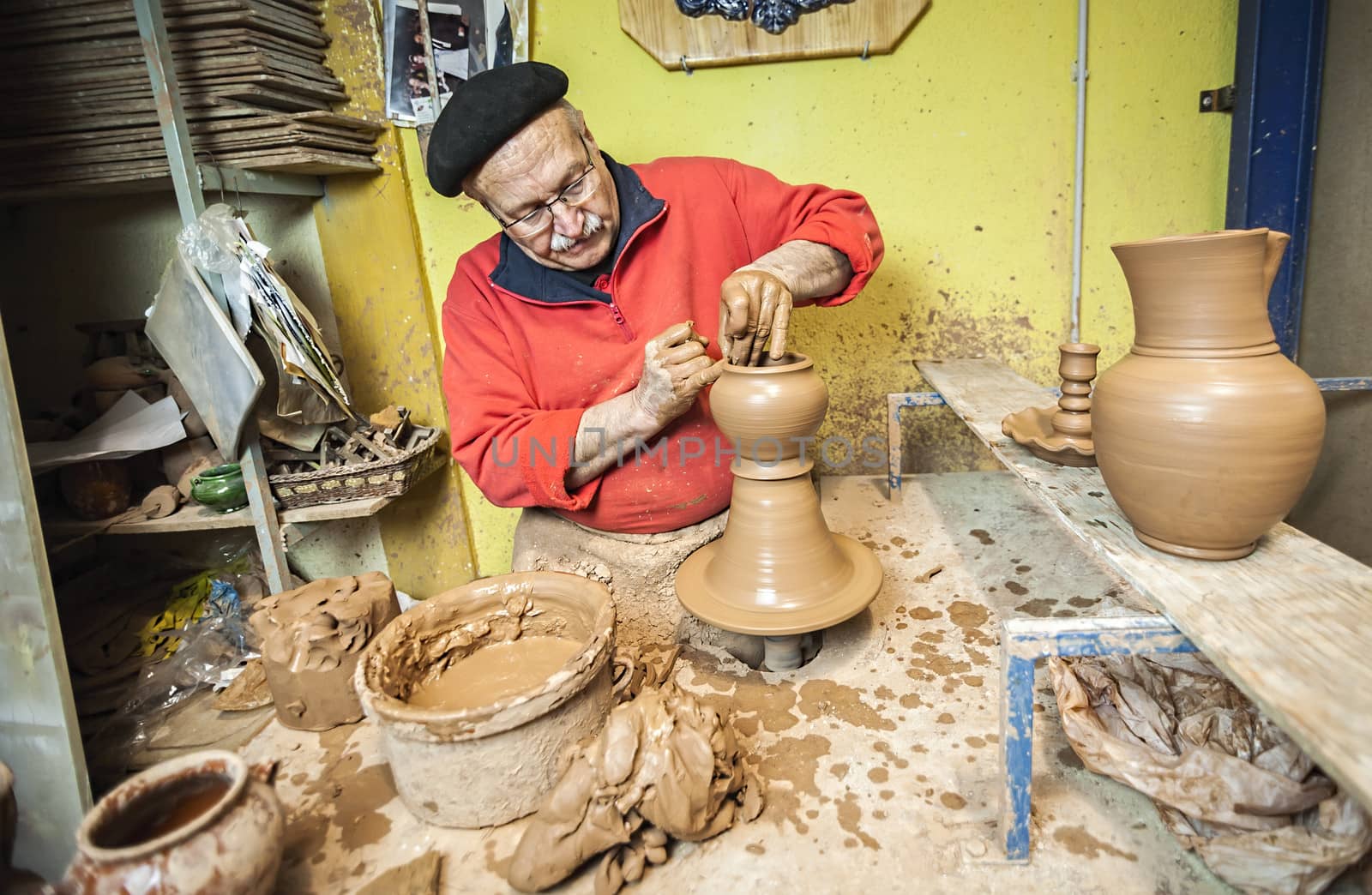 Potter working in workshop a ceramic piece typical of Bailen by digicomphoto