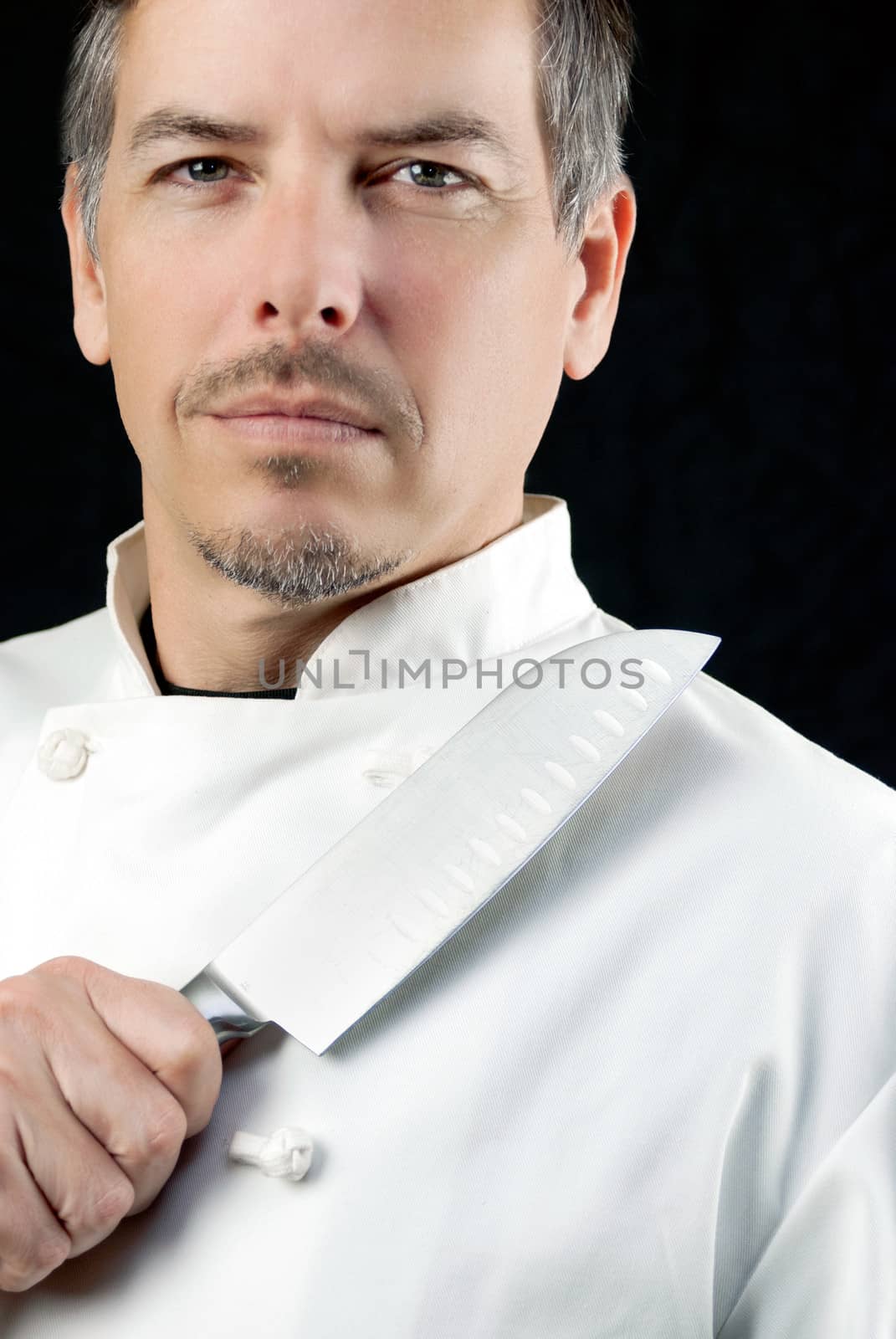 Close-up of a chef displaying his knife, potrait.