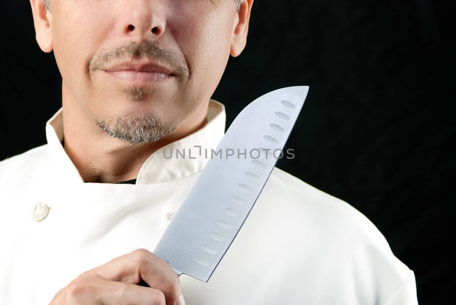 Close-up of a chef displaying his knife.