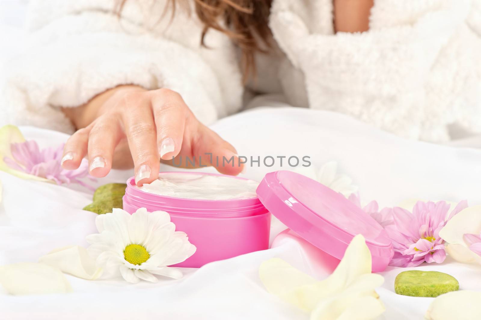 female's hand taking cream