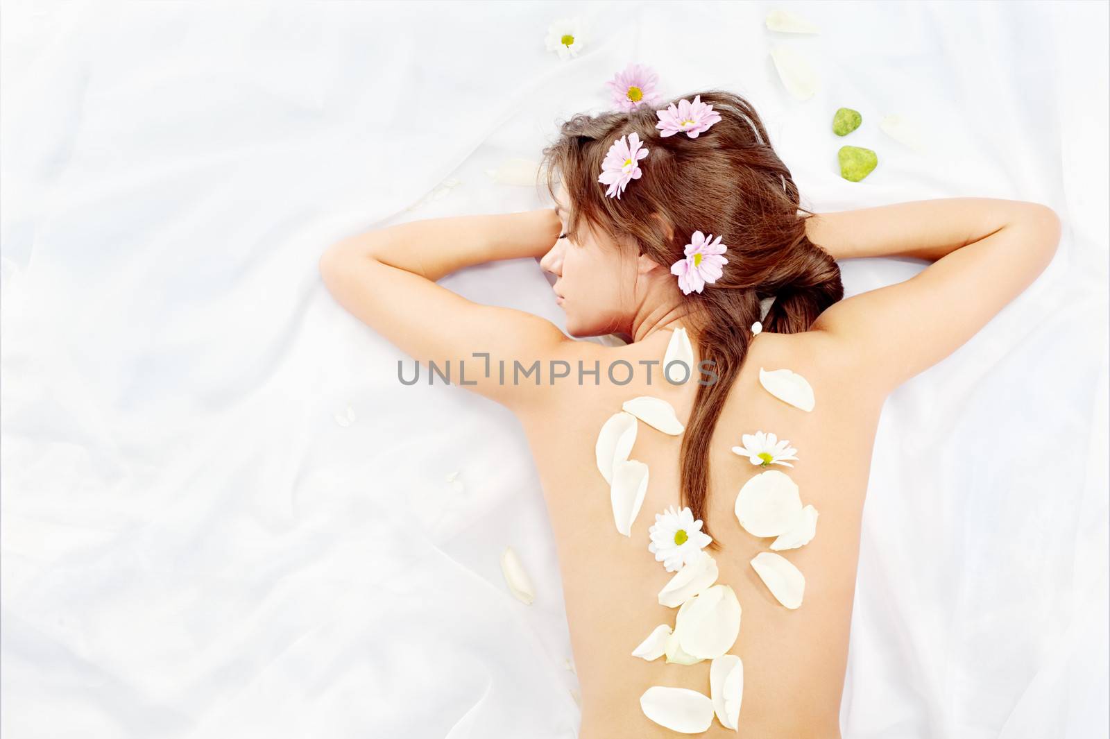 women's back covered with petals and flowers by imarin