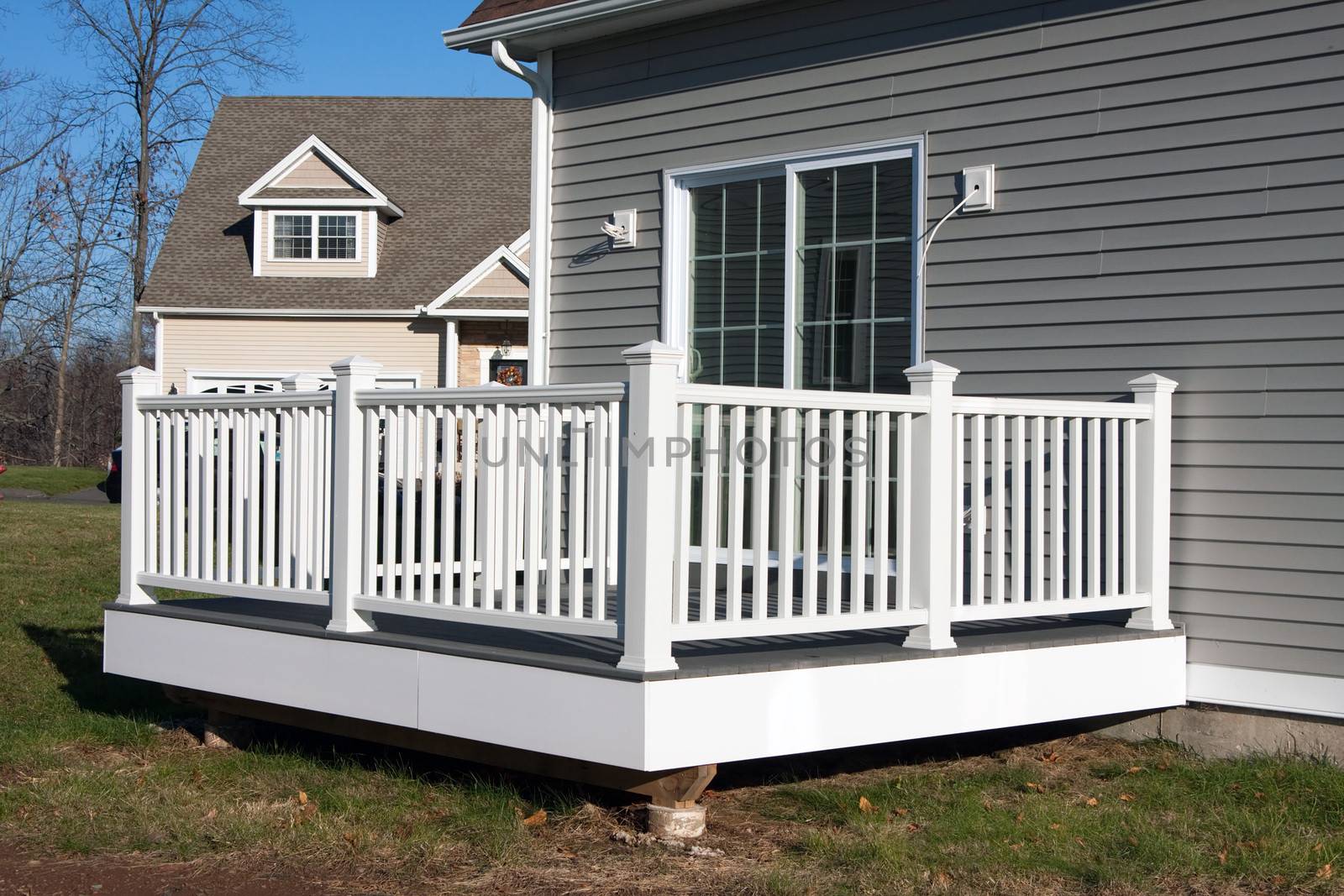 Rear view of a modern custom built house newly constructed with a walk out porch.  