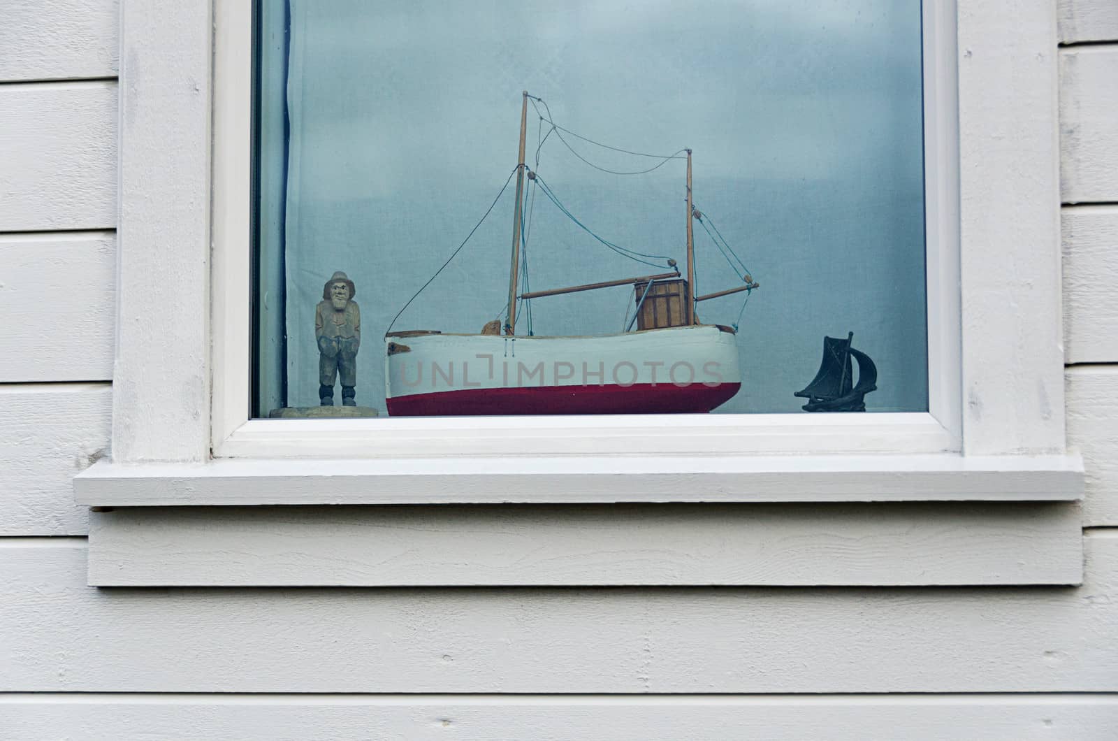 old fisherman with his boat in a window