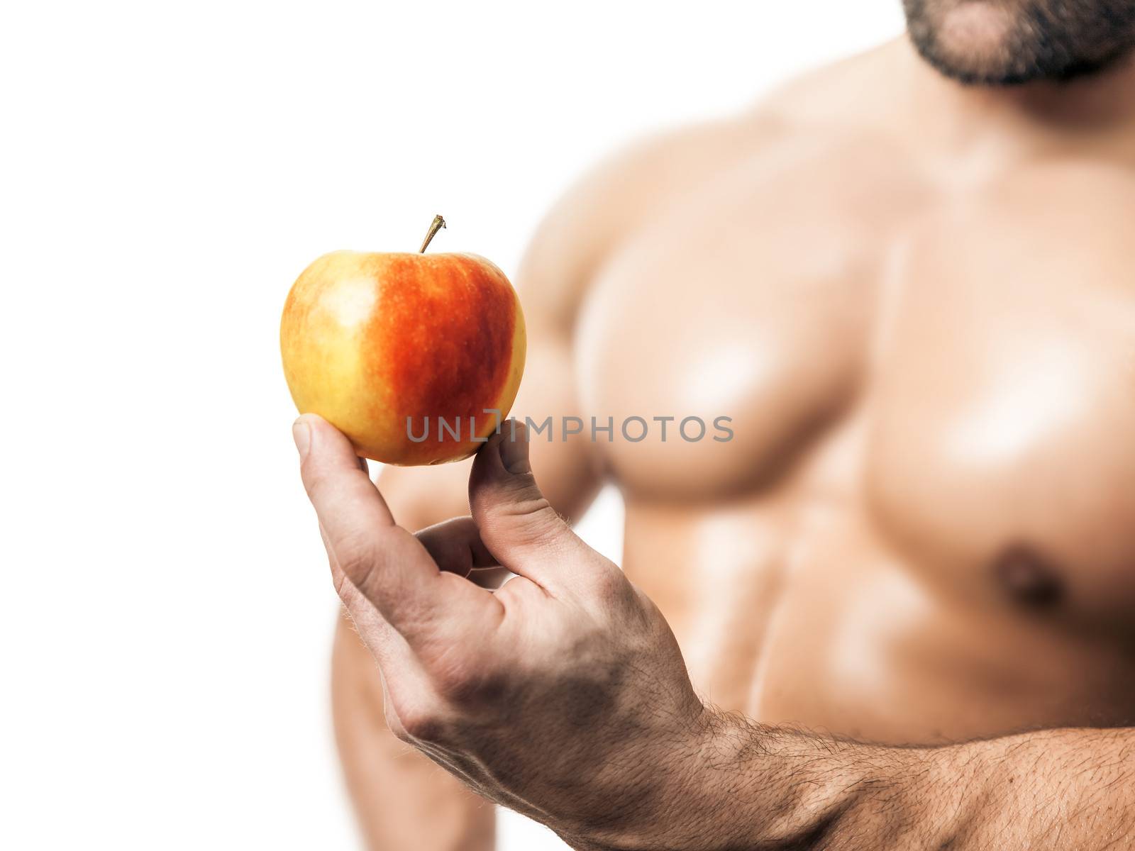 An image of a handsome young muscular sports man and a apple