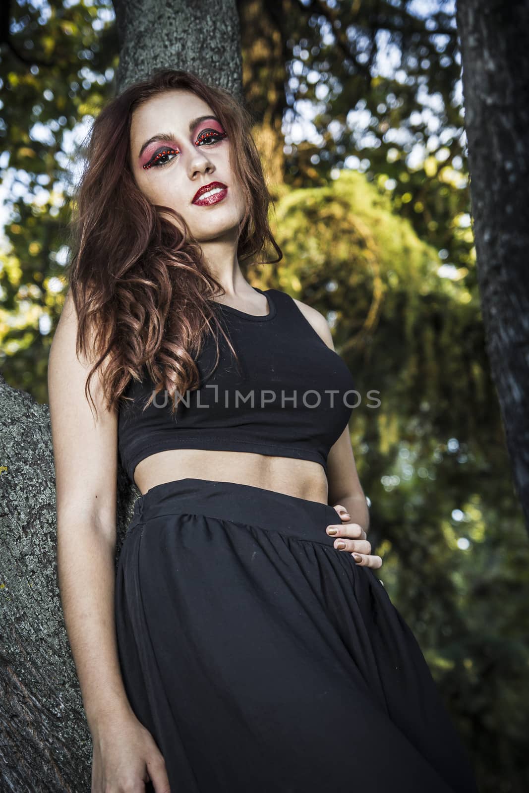 redheaded girl sitting on the log in forest by FernandoCortes