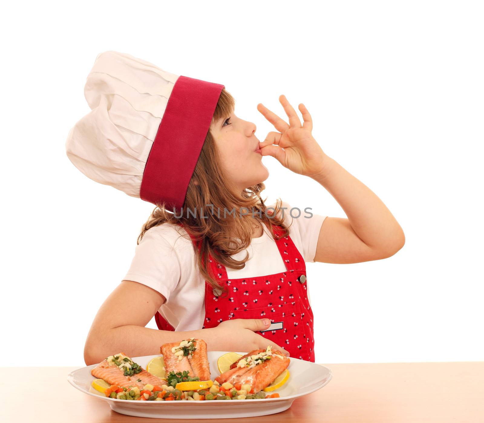 little girl cook with ok hand sign and salmon on dish by goce