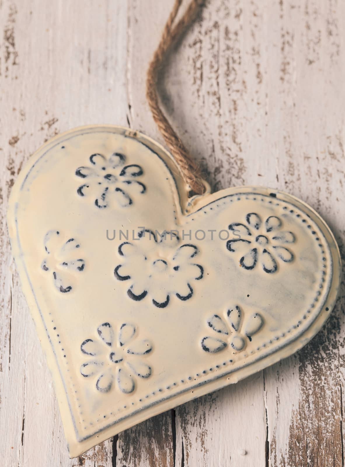 Metal heart on the shabby wooden background