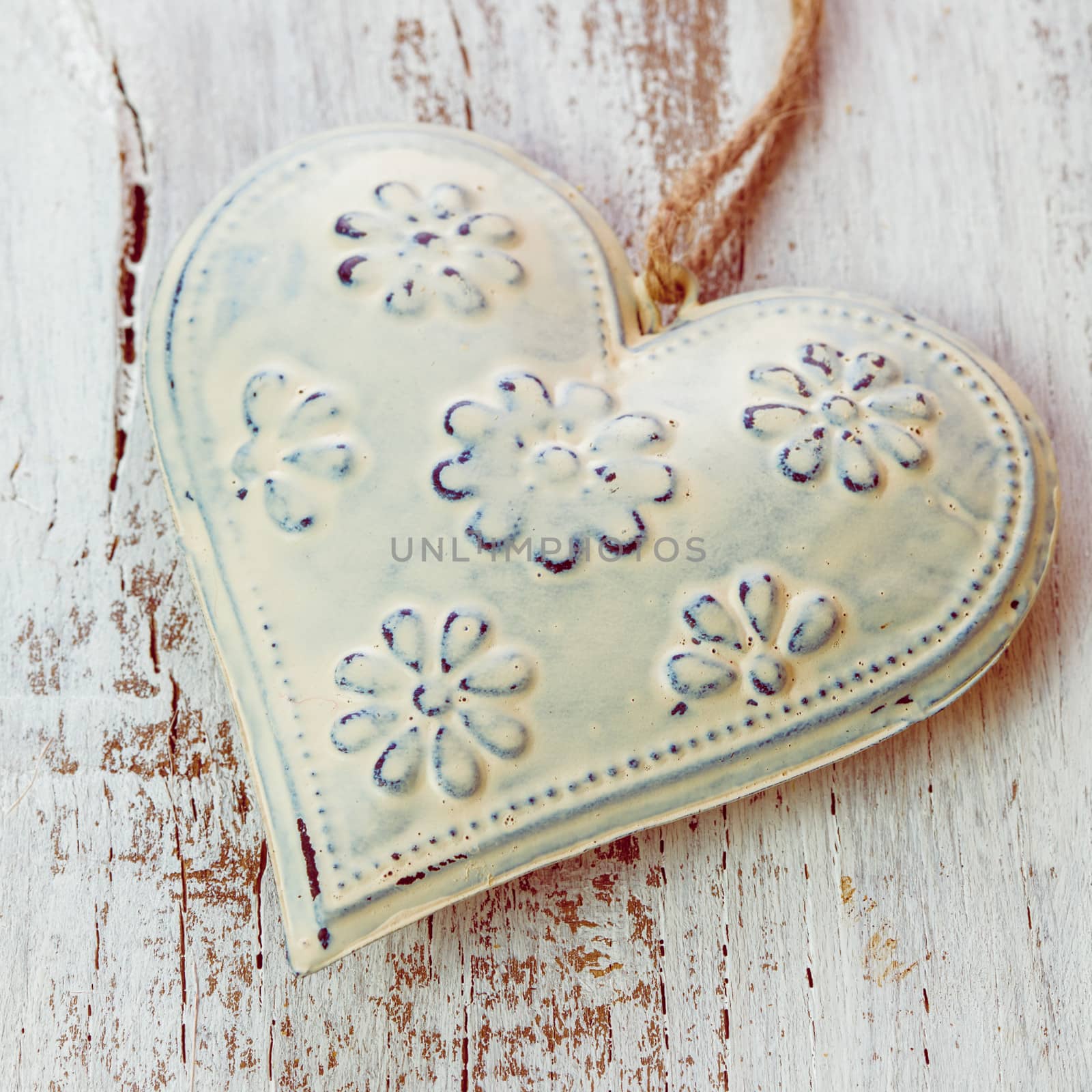 Metal heart on the shabby wooden background