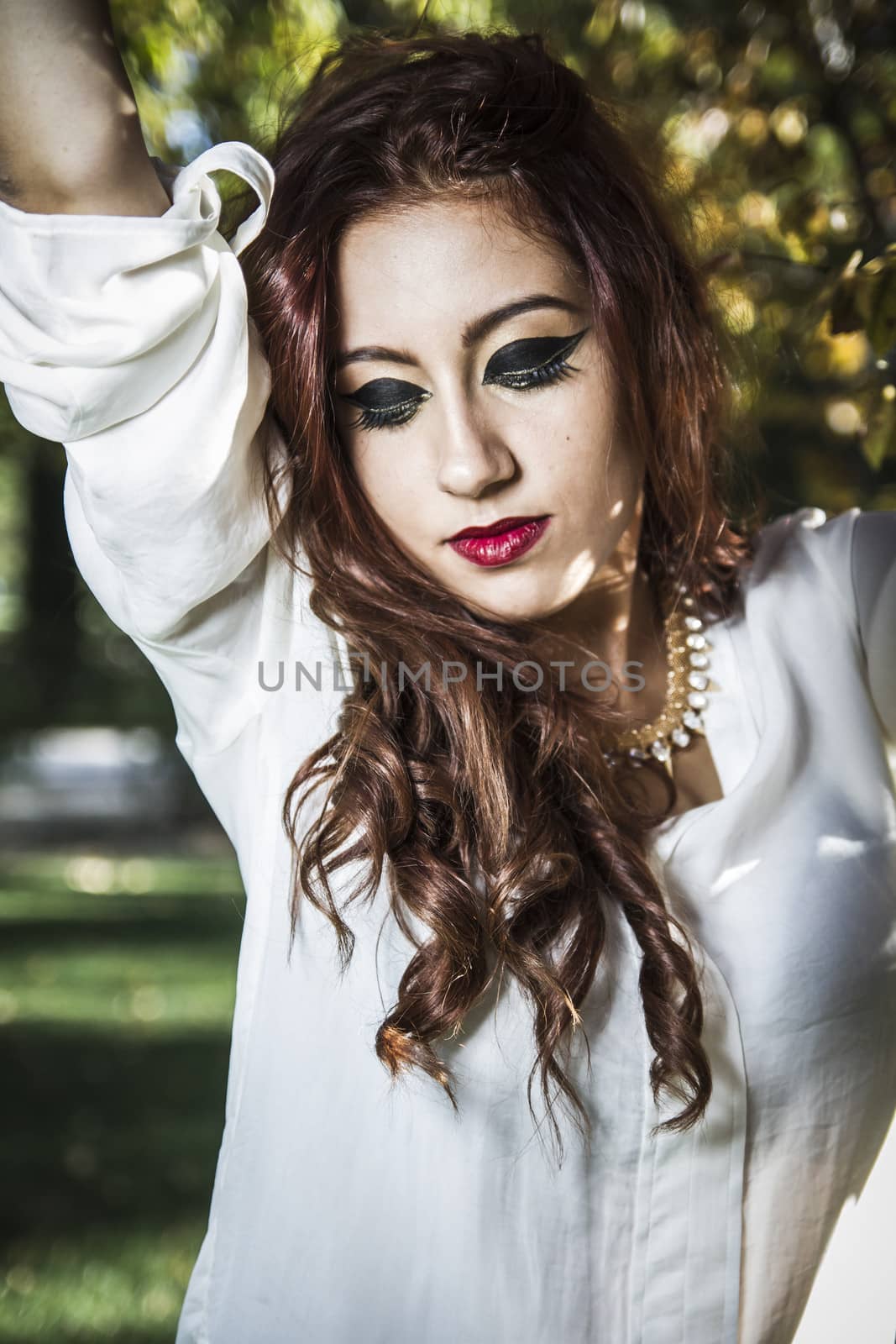 Portrait of young attractive smiling woman wearing white t-shir by FernandoCortes