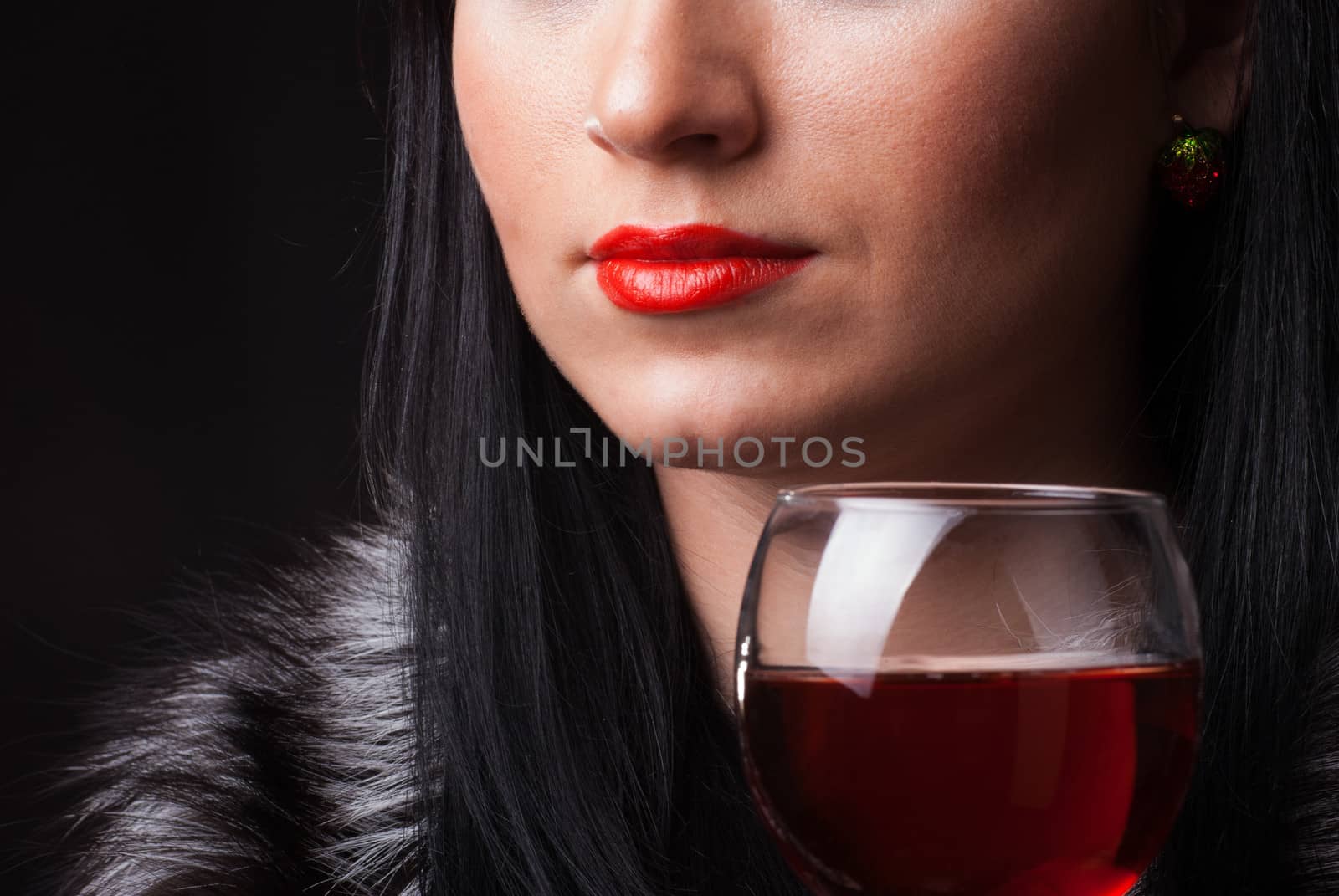 Red lips and glass of wine close up