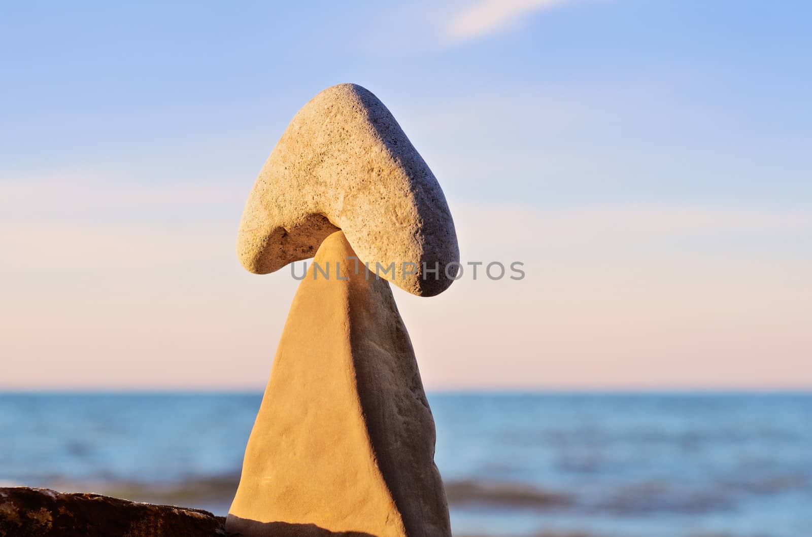 Balancing of pebbles on the top of triangle stone