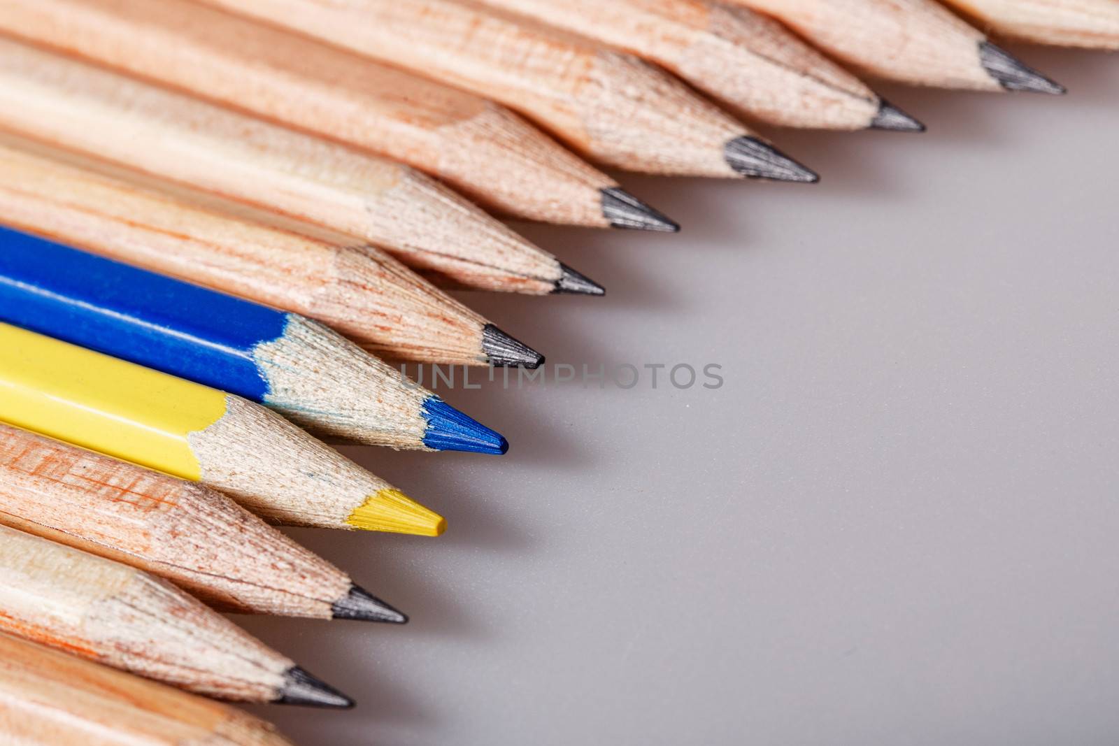 Color pencil stands out against a series of graphite pencils