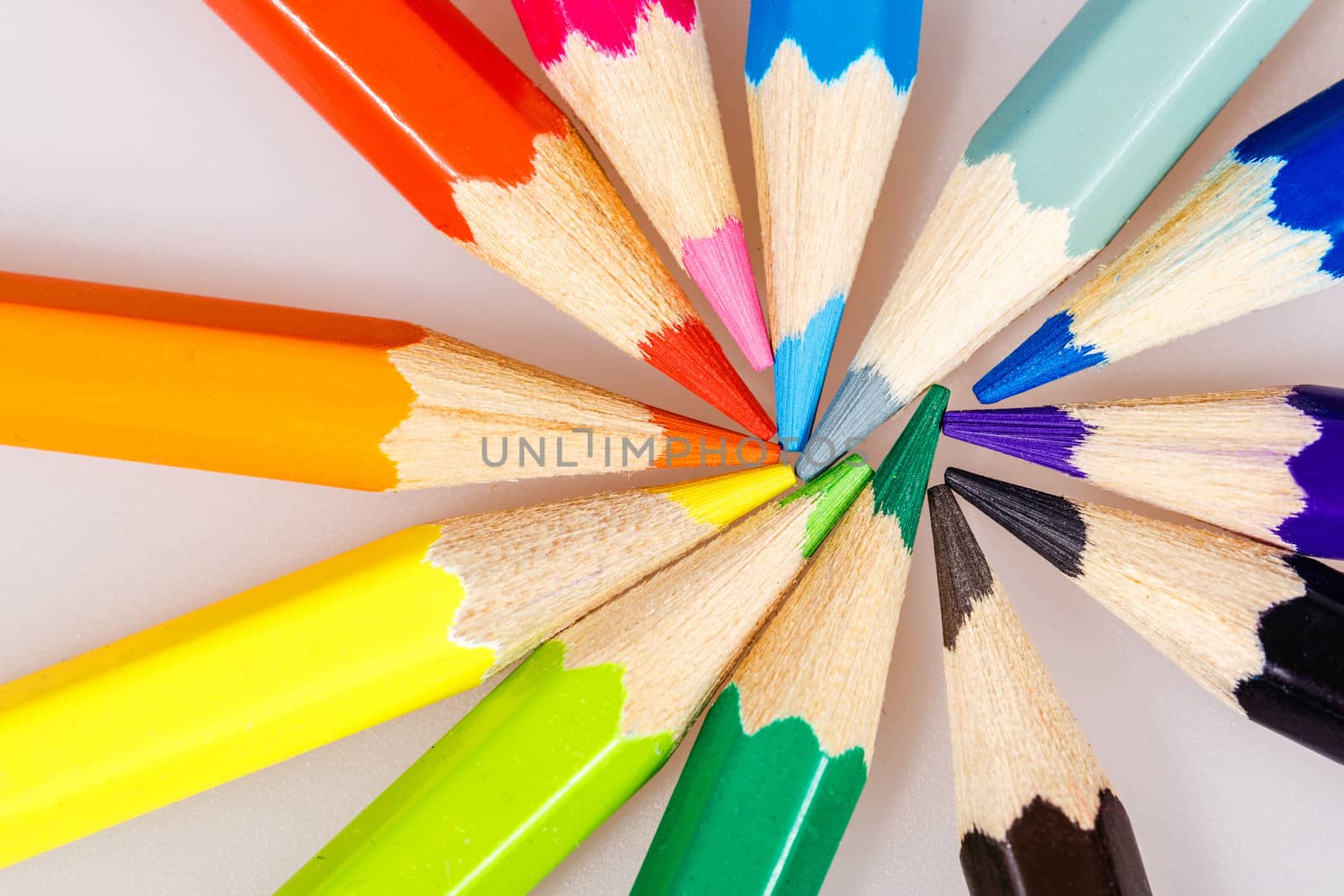 Brightly colored wooden pencils closeup shot background