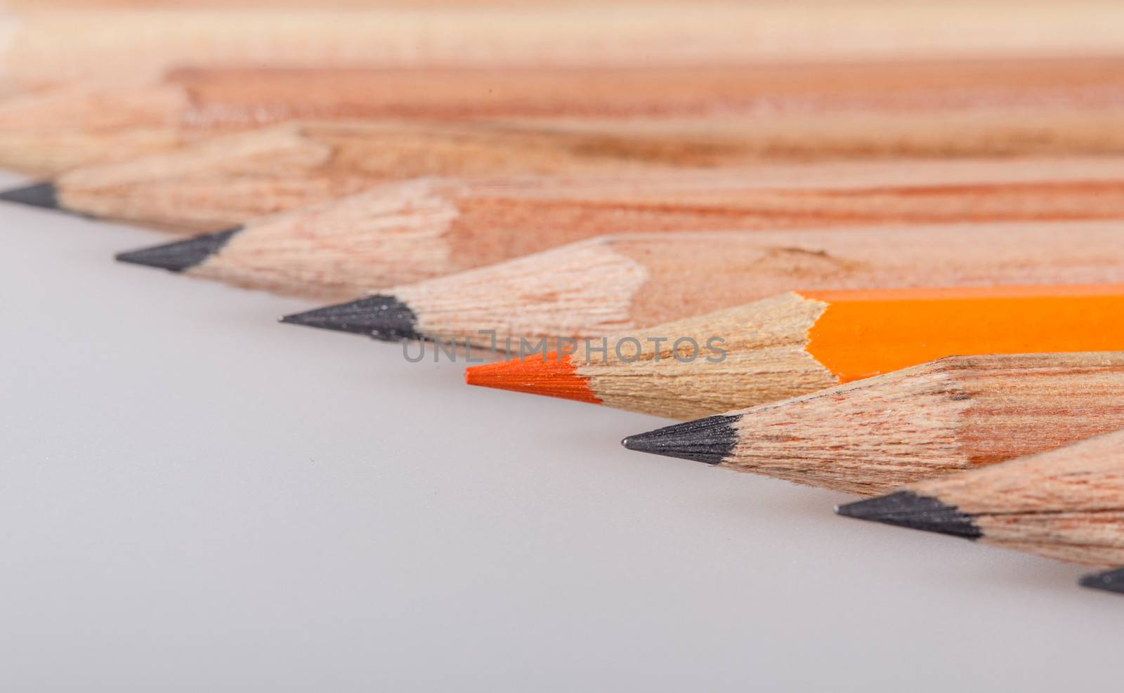 Color pencil stands out against a series of graphite pencils