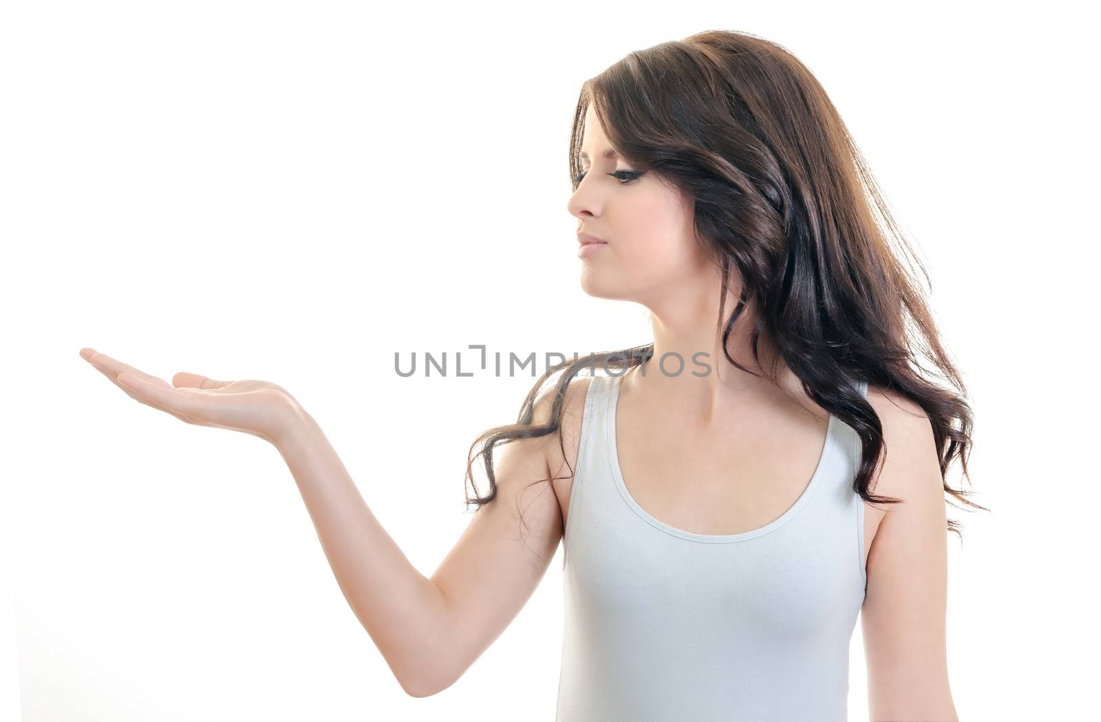 portrait of young beautiful brunette woman posing with empty hand palm up, holding imaginary object