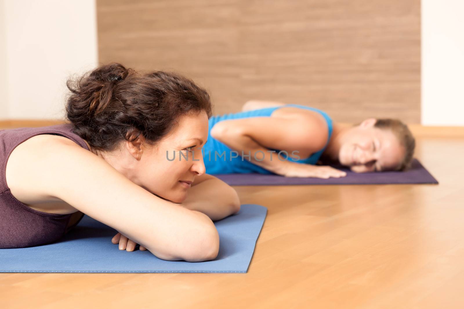 An image of some people relaxing after yoga exercises