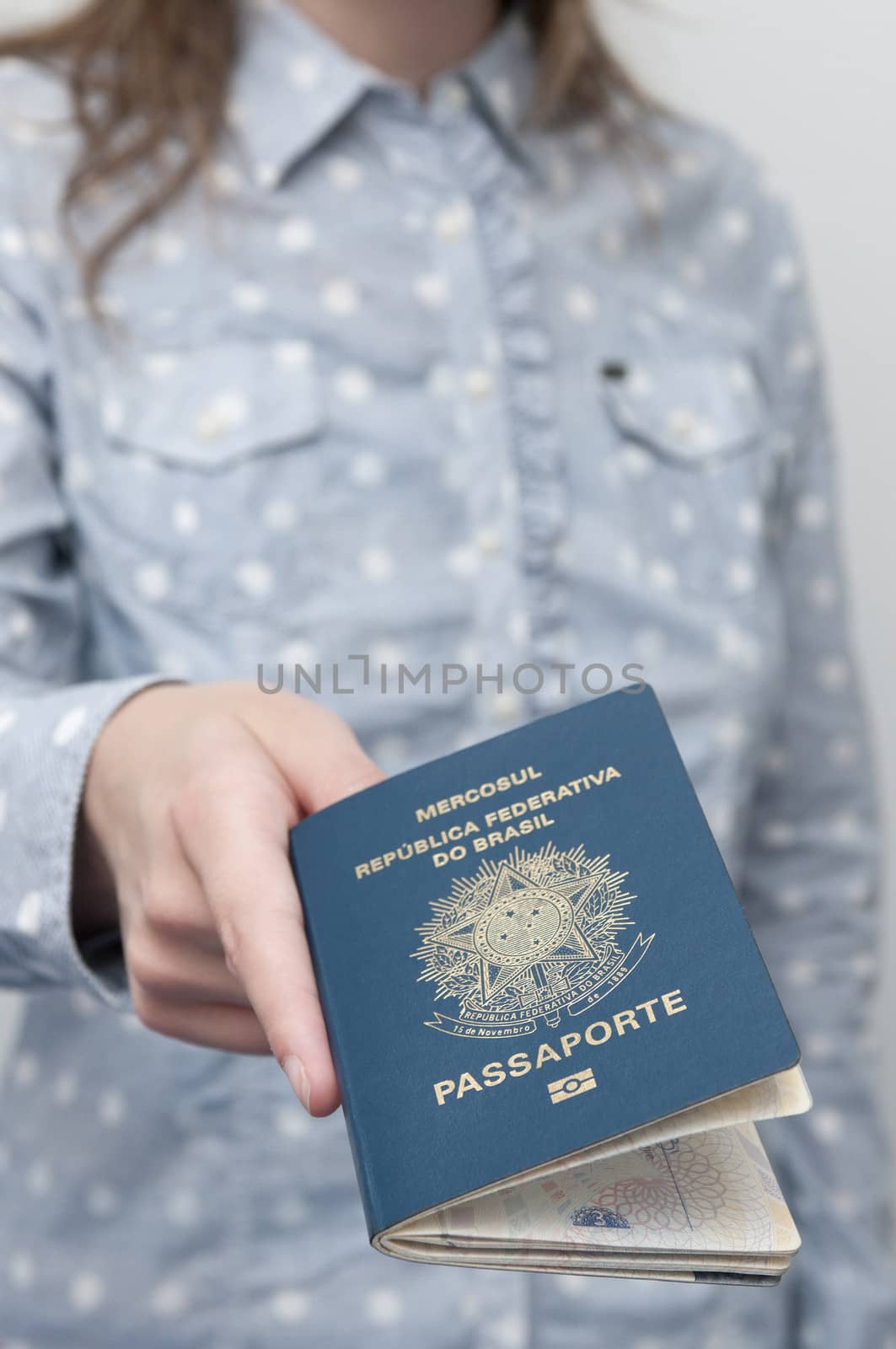 Caucasian Woman holding a brazilian passport by rodrigobellizzi