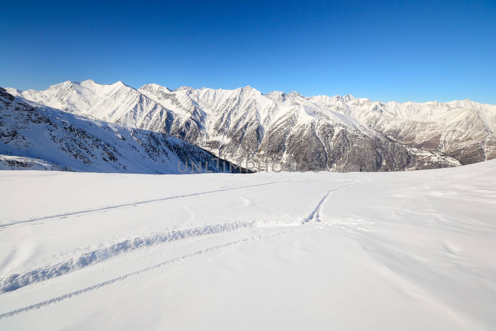 Ski touring tracks (back country ski tracks) in majestic high mountain scenery, italian Alps