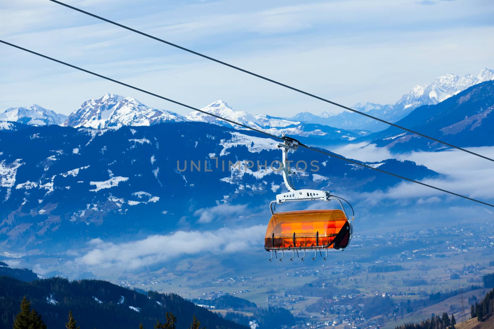 Cable car on the ski resort in Austria. On the background blue sky.