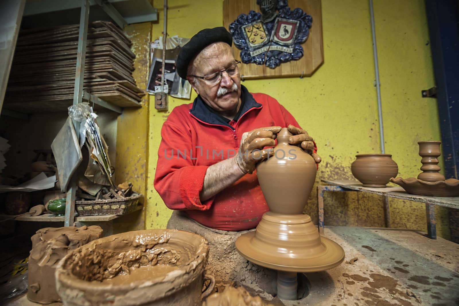 Potter making a water jug in classic mud, clay pottery ceramics typical of Bailen, Jaen province, Andalucia, Spain