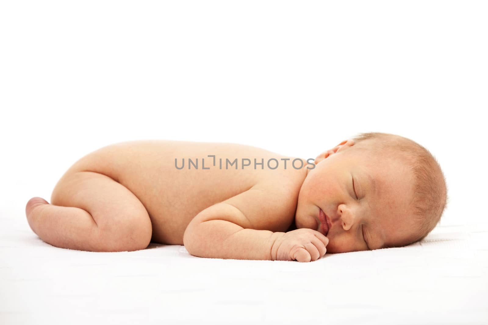 Newborn baby boy asleep over white background