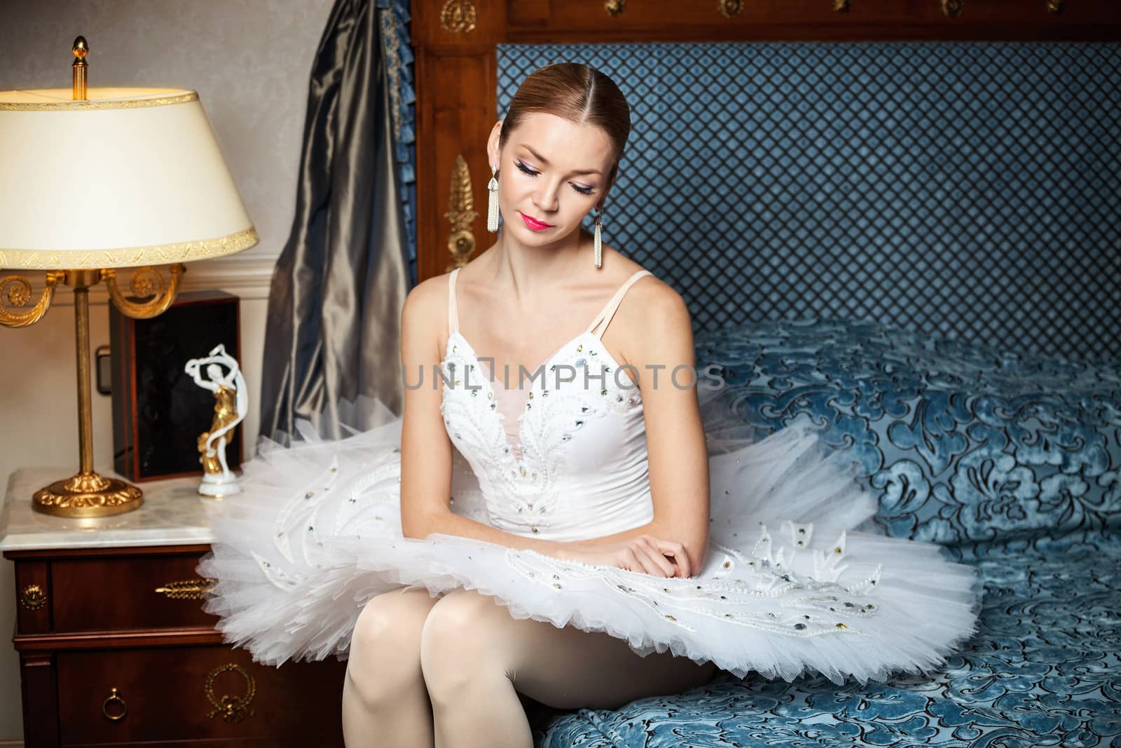 Professional ballet dancer sitting on sofa by photobac