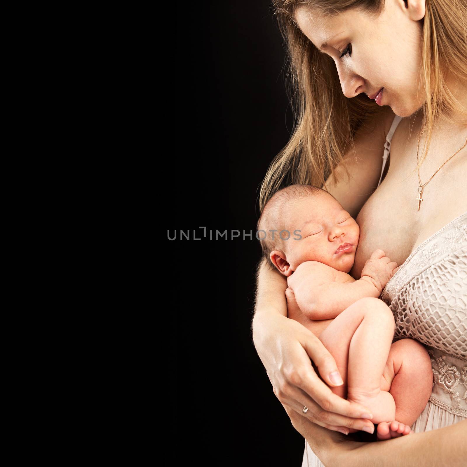 Young caucasian woman holding newborn son by photobac