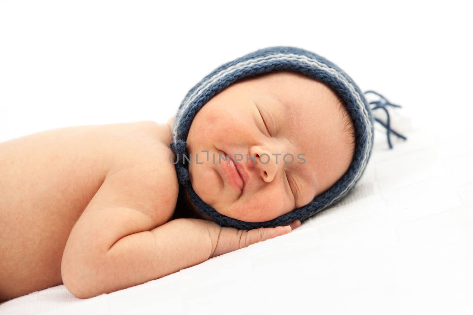 Newborn baby boy asleep over white background