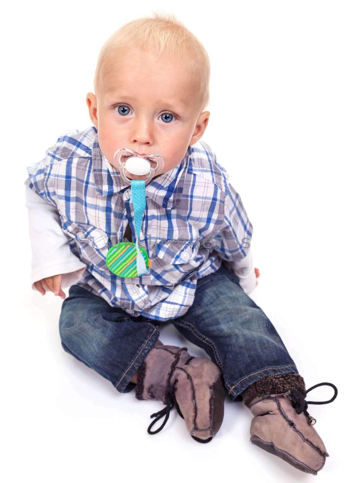 Cute blonde blue-eyed little boy with a pacifier over white background