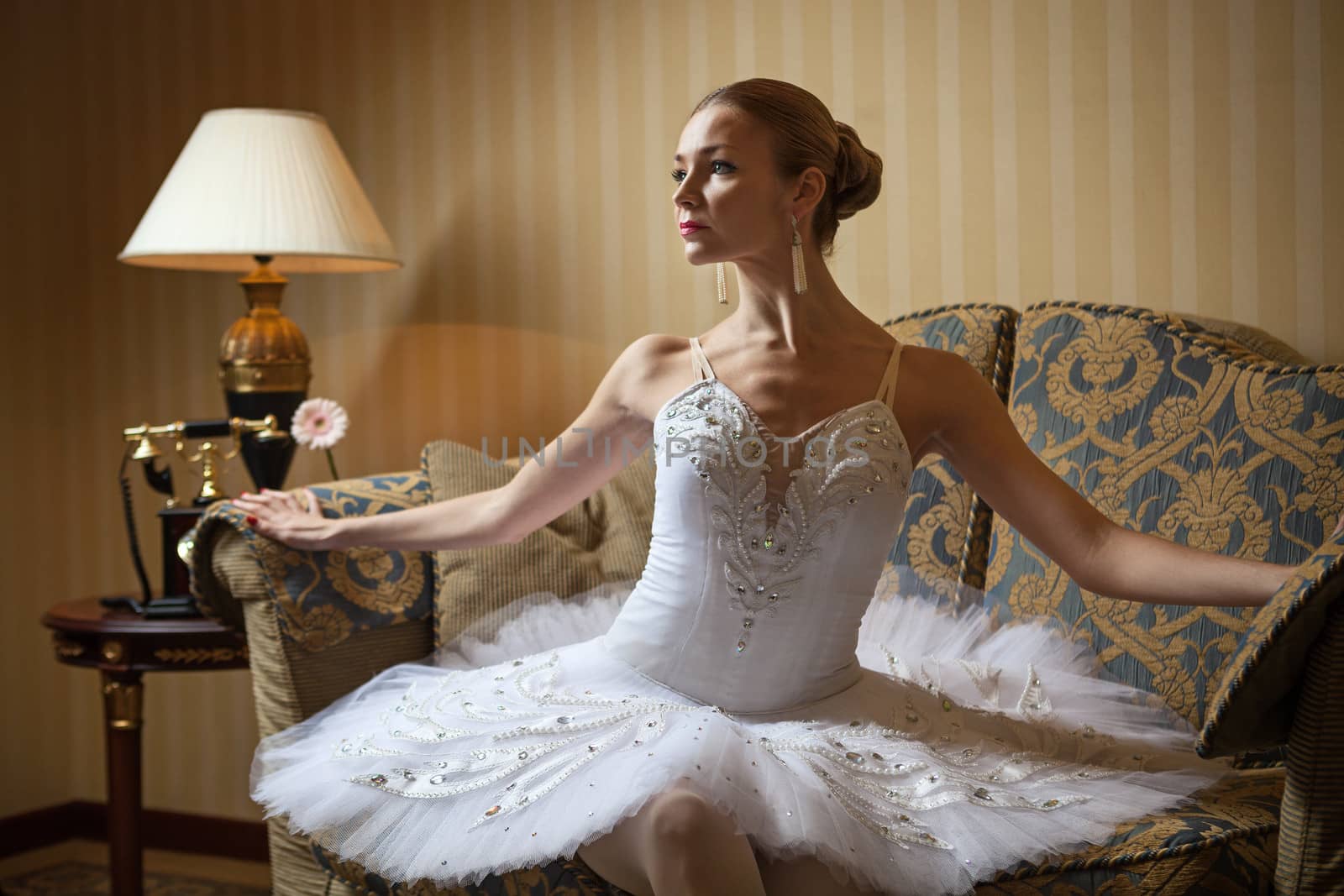 Professional ballet dancer sitting on sofa by photobac