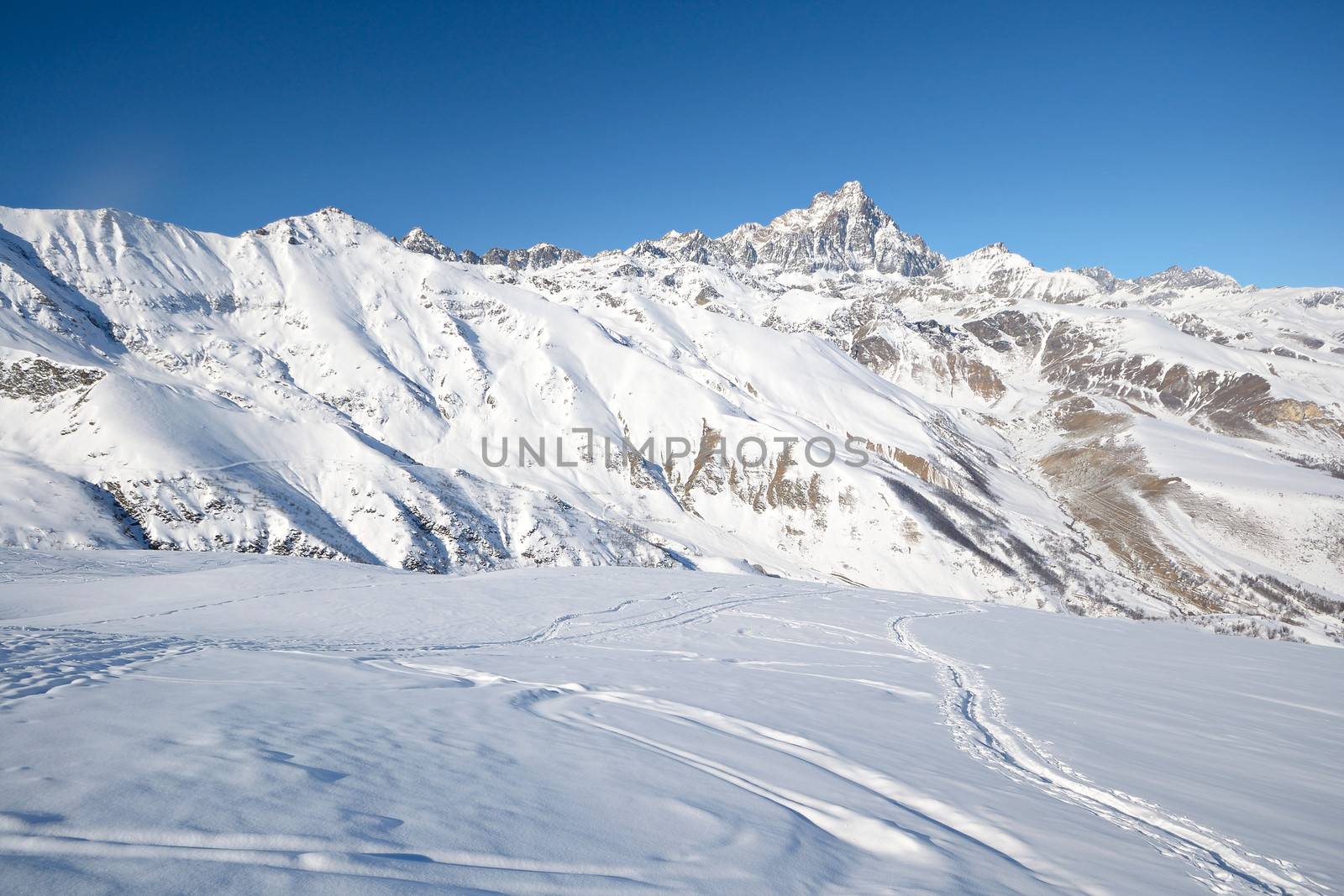 Ski touring tracks (back country ski tracks) in majestic high mountain scenery, italian Alps