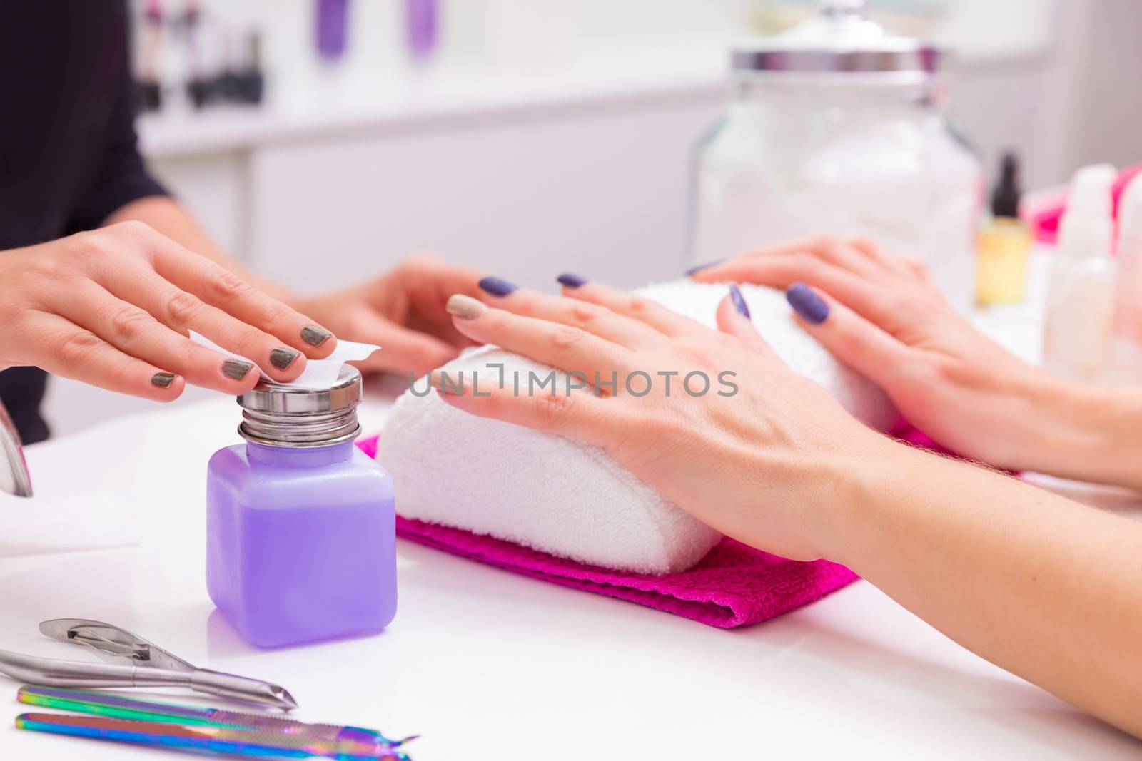 Nails saloon woman nail polish remove with tissue by lunamarina