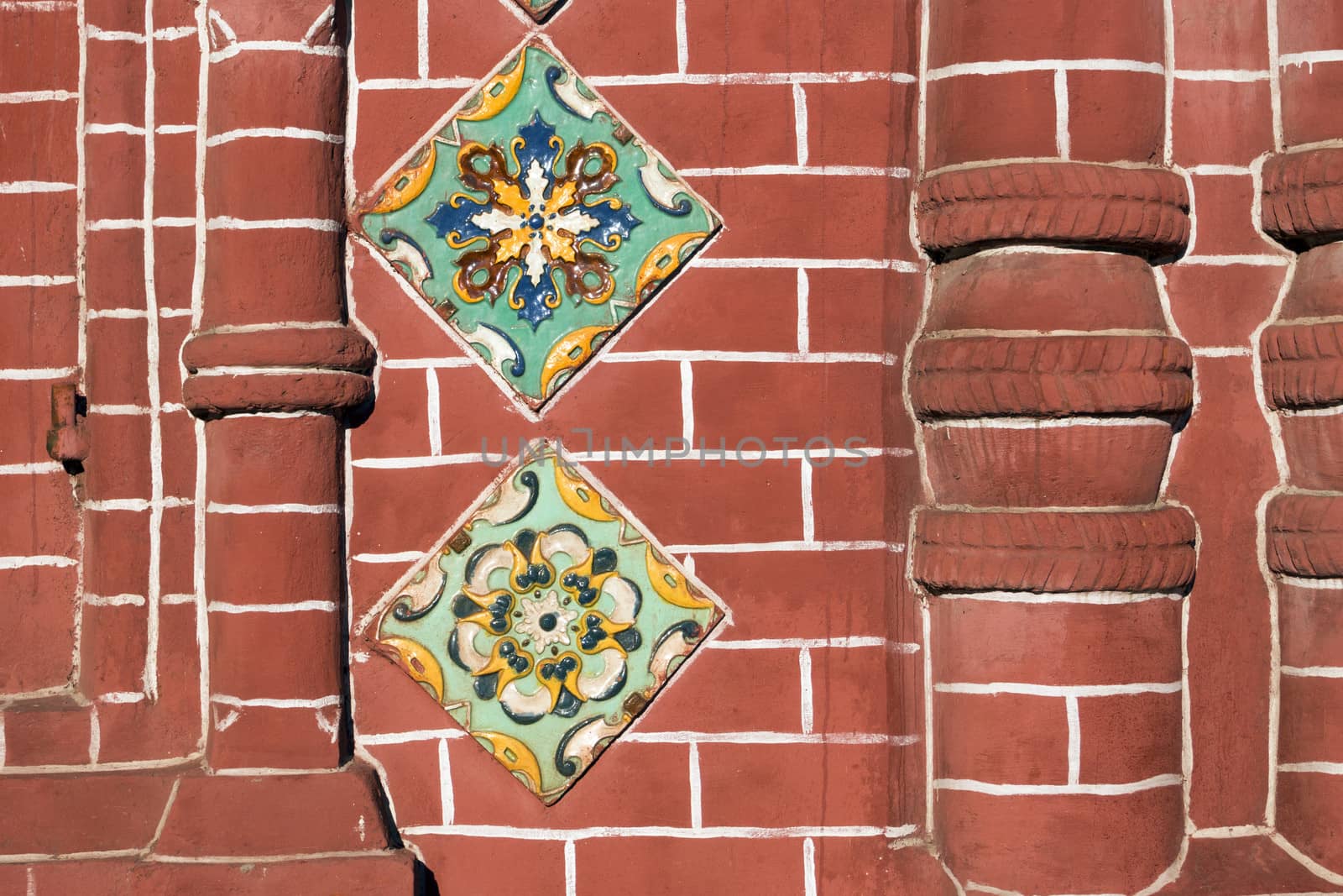 detailed red brick wall fragment of ancient Russian Orthodox Church in Yaroslavl city with traditional ceramic tile decoration
