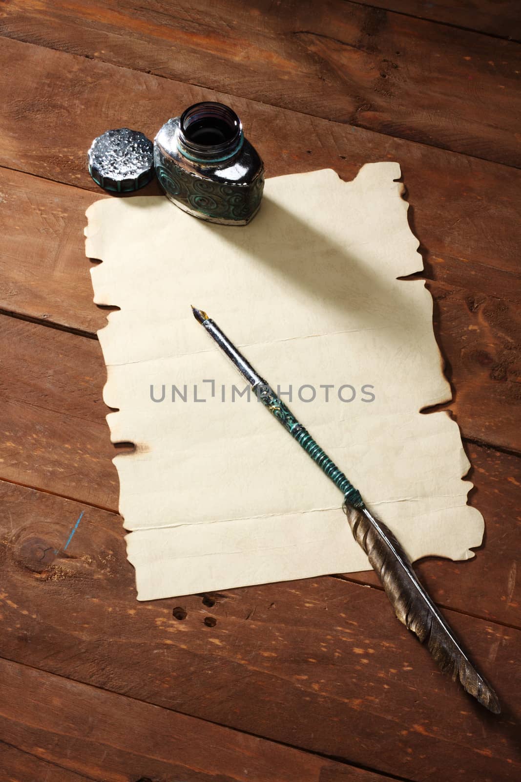 A blank sheet of paper and quill.