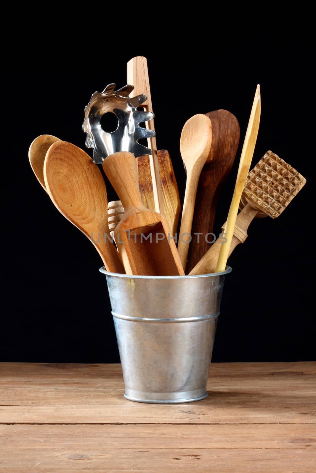 wooden kitchen utensils in metal pot