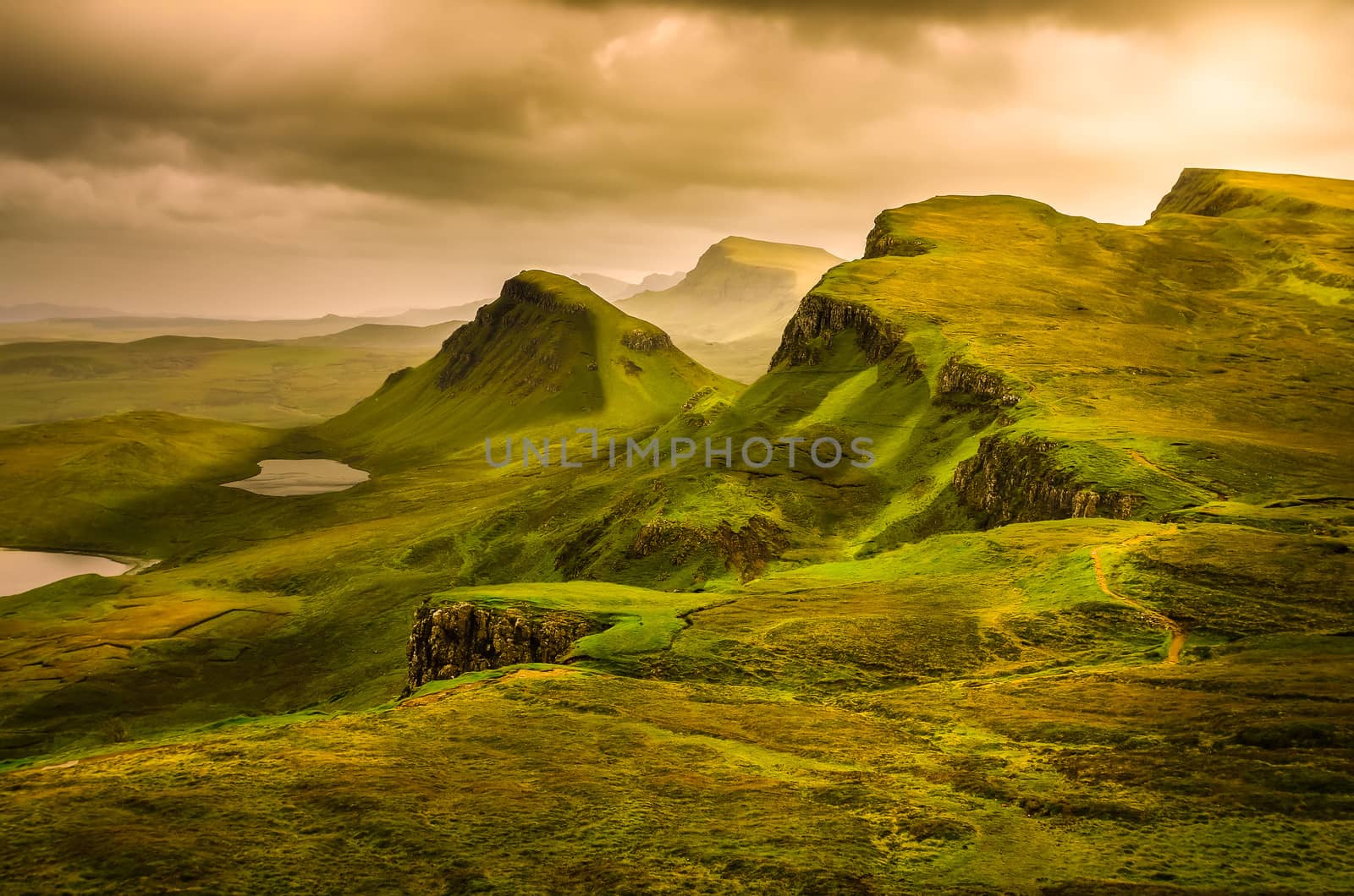 Scenic view of Quiraing mountains sunset with dramatic sky in Scottish highlands, Isle of Skye, United Kingdom